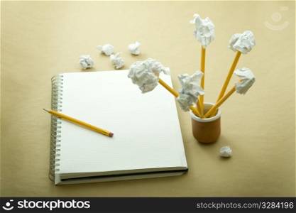 flower made of crumpled paper, notebook and pencil