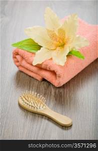 flower on pink towel with hairbrush
