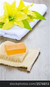 flower on towel and soap on bast
