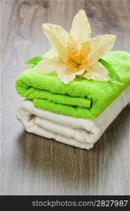 flower on towels on wooden background