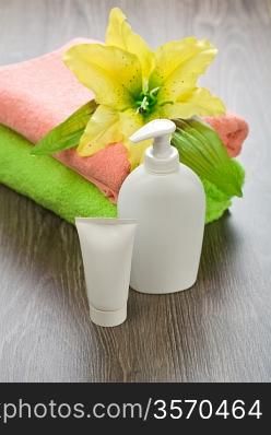 flower on towels with tube and bottle