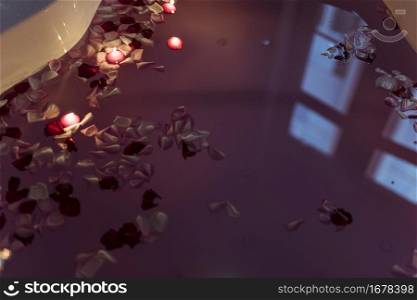 flower petals water near burning candles spa tub