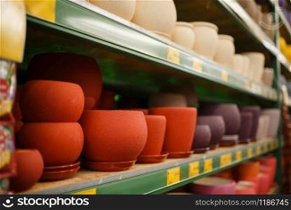 Flower pots assortment on the shelf, shop for floristry, nobody. Equipment variation in store for floriculture, florist instrument choice