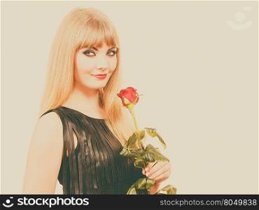 Flower, romantic people. Beautiful young lady with red rose. Long haired, blonde girl has black leather outfit. Woman has nice make up.