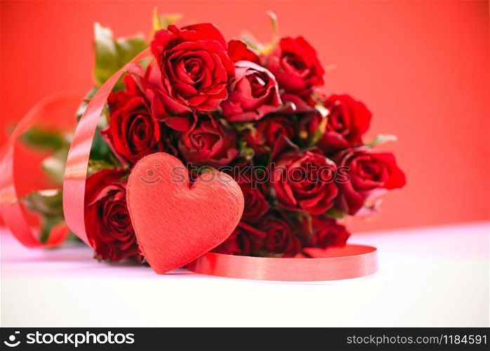 Flower roses bouquet on red background / Red heart with ribbon and rose romantic love valentine day concept