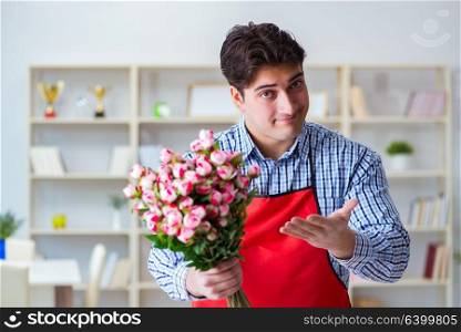 Flower shop assistant offering a bunch of flowers