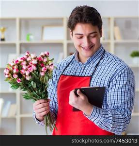 Flower shop assistant offering a bunch of flowers