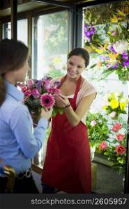 Flower shop owner helping customer