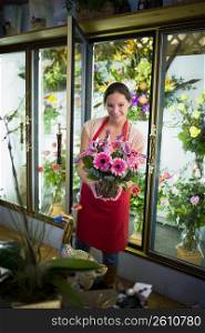 Flower shop owner holding arrangement