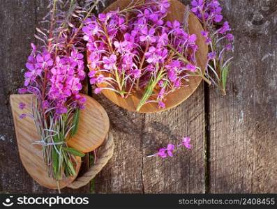 Flower Willowherb - Epilobium Angustifolium on wooden background . Top view .. Flower Willowherb - Epilobium Angustifolium on wooden background. Top view