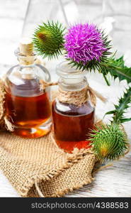 Flowering buds plant Thistle, and a small bottle of medicinal tincture