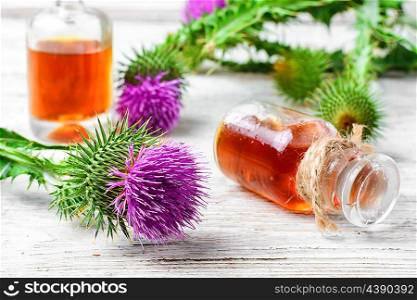 Flowering buds plant Thistle, and a small bottle of medicinal tincture