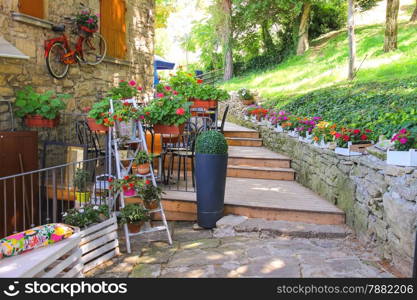Flowers and bicycle in the external design of the outdoor restaurant in San Marino
