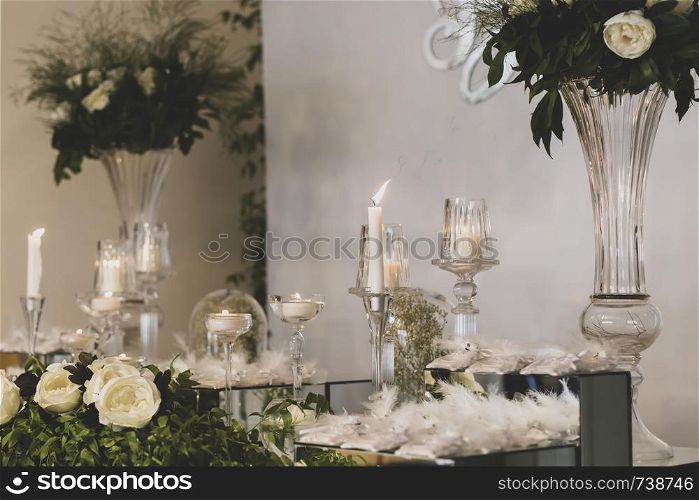 flowers and candles on the decorated table