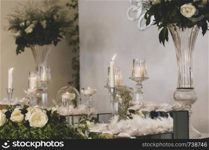 flowers and candles on the decorated table