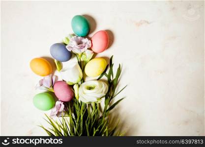Flowers and eggs on pink mable background, copy space for Easter greetings. Flowers and eggs