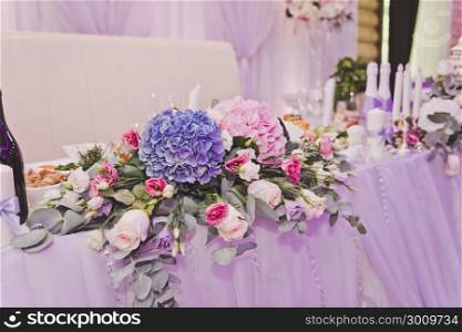 Flowers and other decorations on the wedding table.. Decorating the edges of the wedding table candles 583.