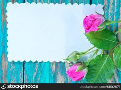 flowers and paper for note on a table