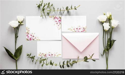 flowers beside wedding invitation