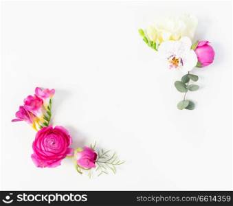 Flowers composition. Frame corners of eucaliptus leaves and ranunculus flowers on white background. Flat lay, top view, copy space. Flowers flat lay composition
