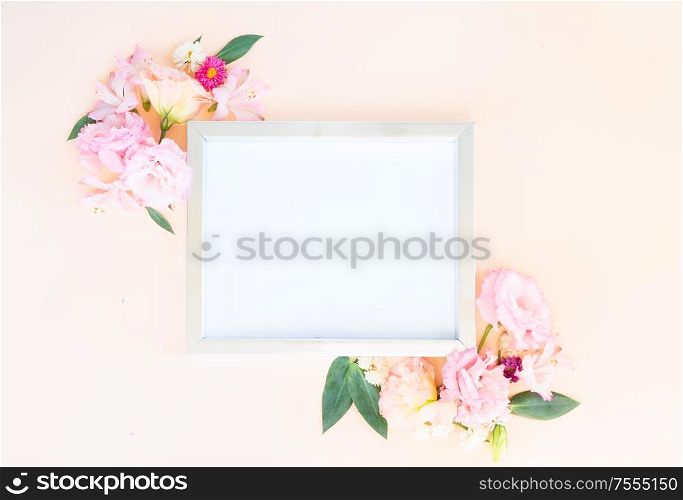 Flowers composition. Frame with lilly and eustoma flowers on pink background. Flat lay, top view scene.. Ranunculus flat lay composition