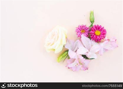 Flowers composition made of daisy and eustoma flowers on pink background. Flat lay, top view scene.. Ranunculus flat lay composition