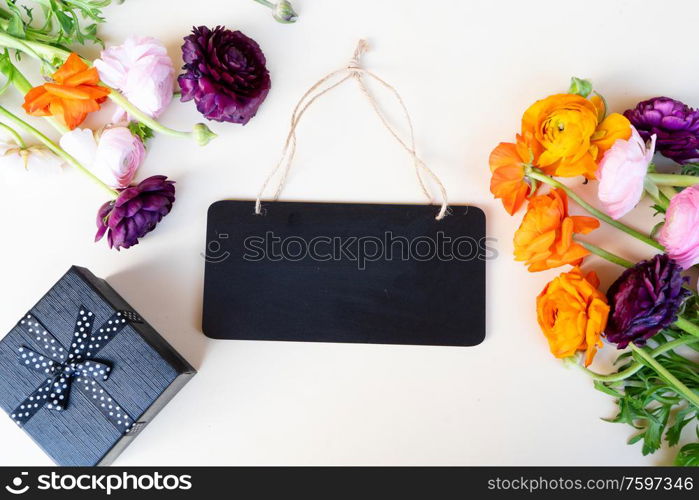 Flowers composition - ranunculus flowers on pink background. Flat lay, top view. Flowers flat lay composition