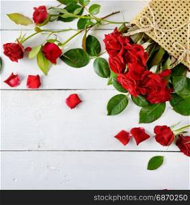 Flowers composition. Red roses on a white wooden background. Flat lay, top view