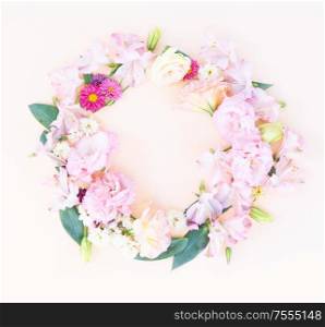 Flowers composition. Round frame made of eustoma flowers on pink background. Flat lay, top view scene.. Ranunculus flat lay composition