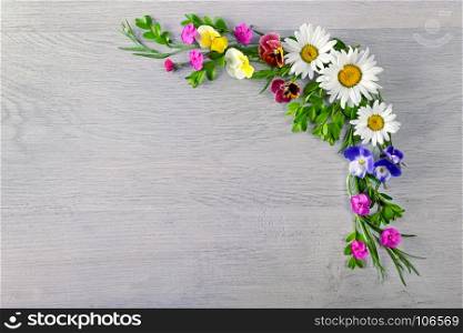 Flowers composition.The frame is made of flowers of chamomiles, violets and phlox. Flat lay, top view. Free space for text.