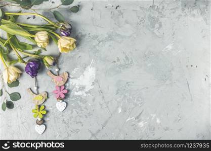 Flowers composition. Violet and light yellow tulip flowers on gray concrete background. Valentine&rsquo;s day, Mother&rsquo;s day concept. Flat lay, top view, copy space