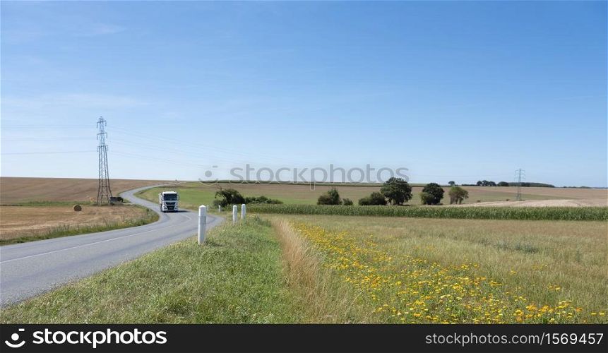 flowers for organic farming in rural landscape of northern france under blue sky