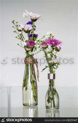 Flowers in the glass bottles decorated living room