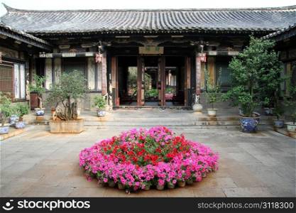 Flowers in the inner ysrd of traditional chinese house, Chgina
