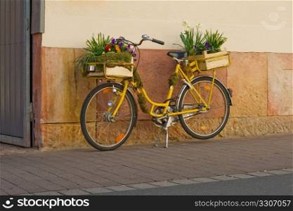 Flowers on a yellow bicycle