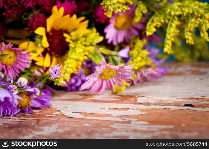 Flowers on old wooden background