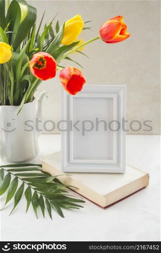 flowers vase frame placed table near wall