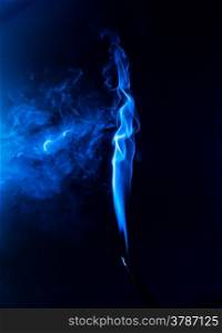 Flowing blue smoke on a black background. Isolated