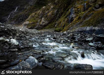 flowing creek in franz josef glacier southland new zealand