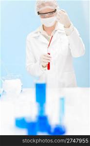 Flu virus vaccination research - woman scientist in laboratory testing, holding test tube