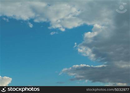 Fluffy clouds decorating a beautirful blue sky