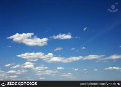 Fluffy clouds in blue sky.