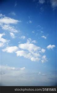 Fluffy cumulus clouds in blue sky.