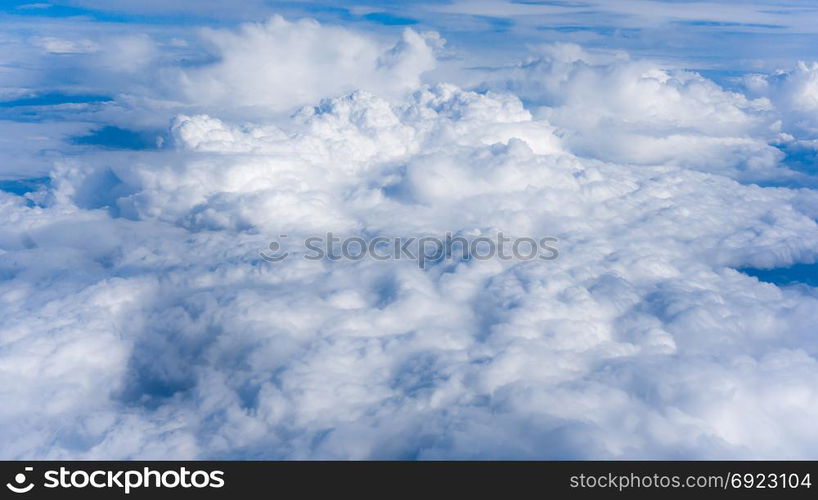 Fluffy White Clouds from Above. clouds and sky