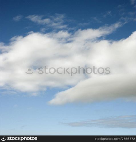 Fluffy white clouds in blue sky.