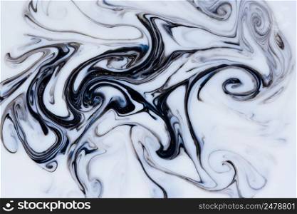 Fluid dark black and gold dust flowing marble abstract background