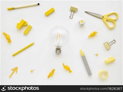 fluorescent bulb surrounded by various stationeries candies