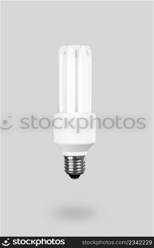 Fluorescent Light Bulb on a gray background ? energy concept