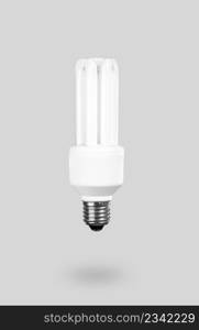 Fluorescent Light Bulb on a gray background ? energy concept