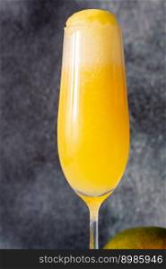 Flute Glass of Mango Mimosa cocktail on gray background